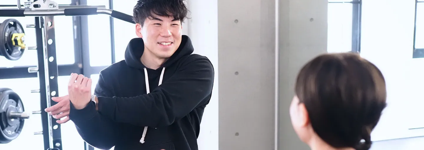 Image of a smiling trainer and a user