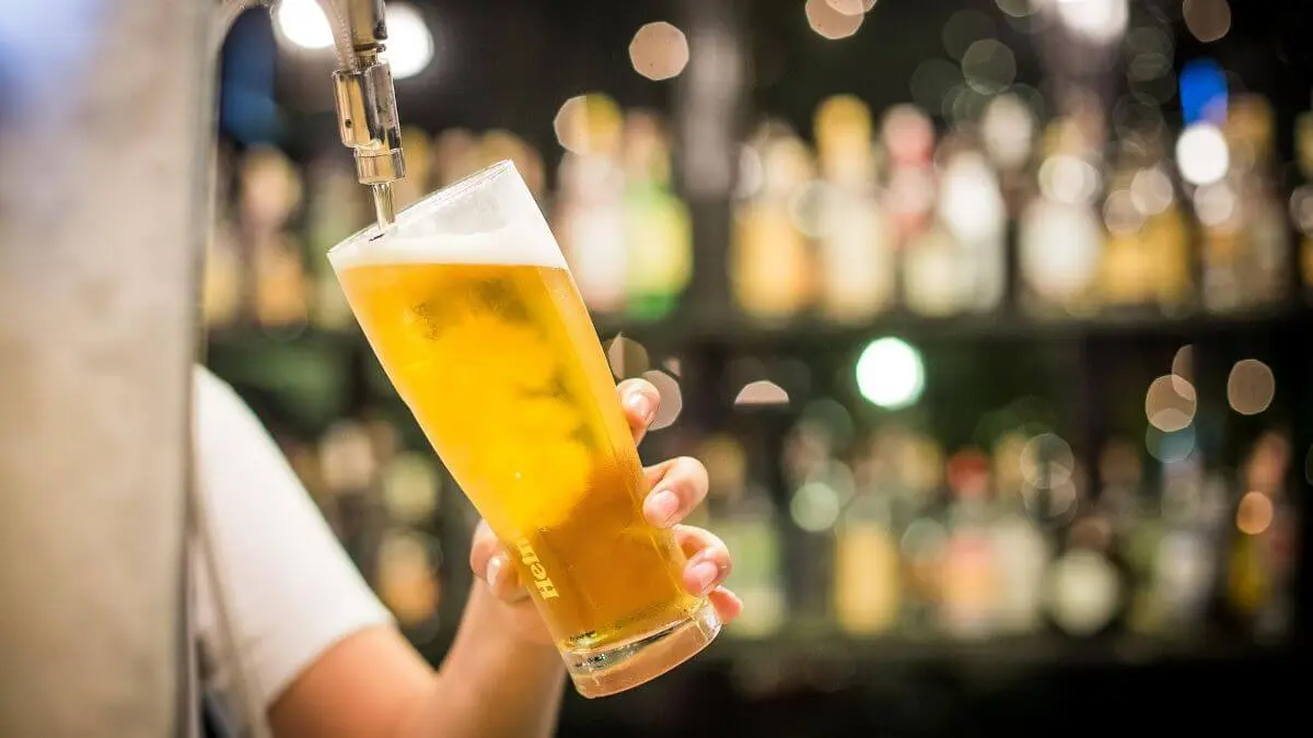 Photo of alcohol being poured into a glass.