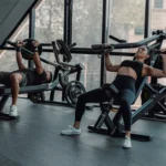 A man and a woman exercising together at a gym