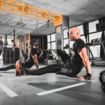 Man doing bodyweight workout in a gym