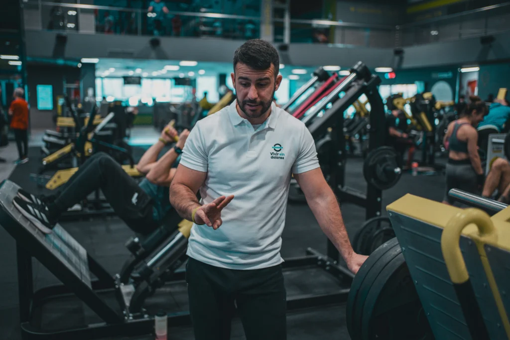 A male personal trainer coaching at the gym