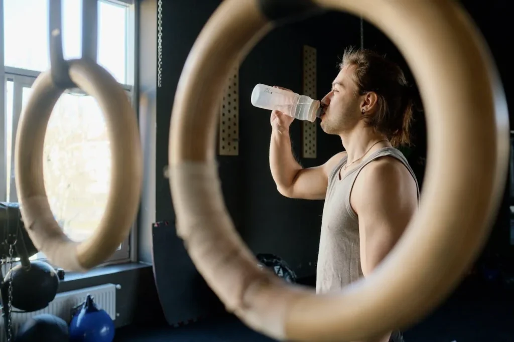 Man taking a hydration break at the gym