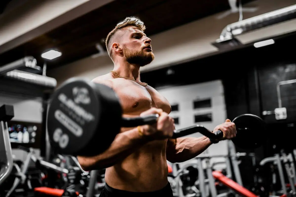 Photo of a man lifting dumbbells for a workout at the gym.