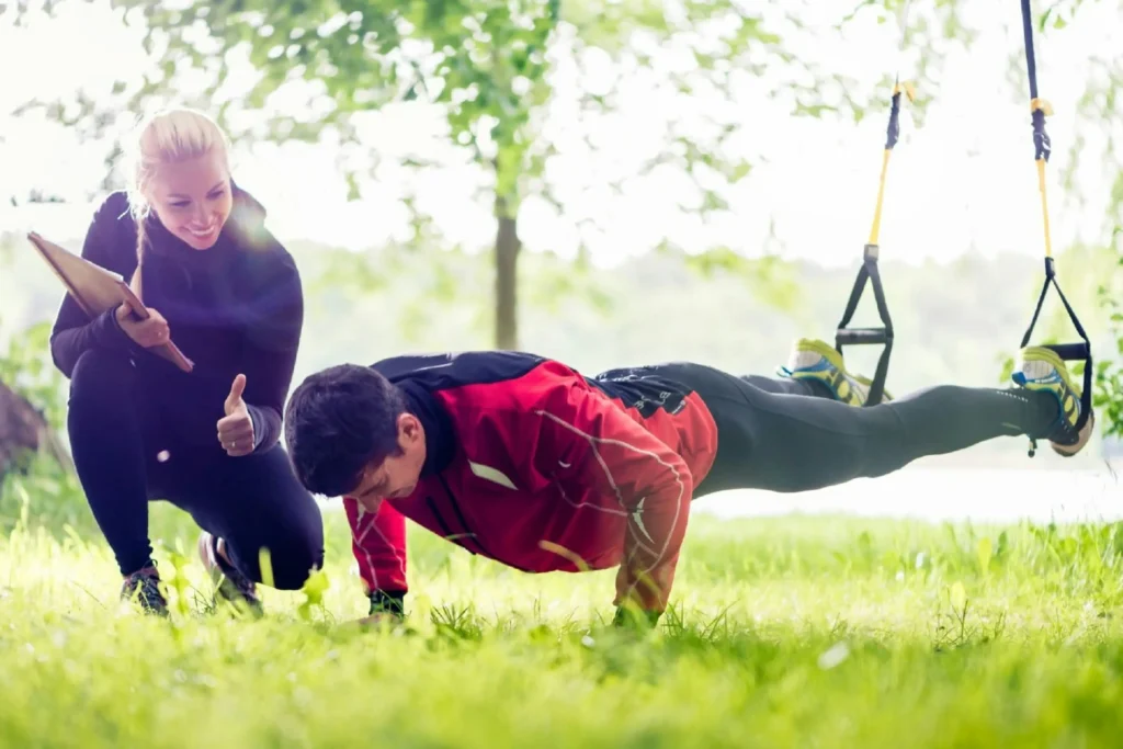 Man receiving personal training from a female trainer