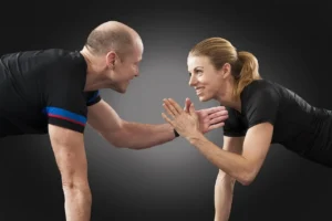A man and a woman working out together at the gym