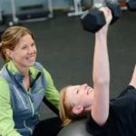 A woman receiving personal training guidance