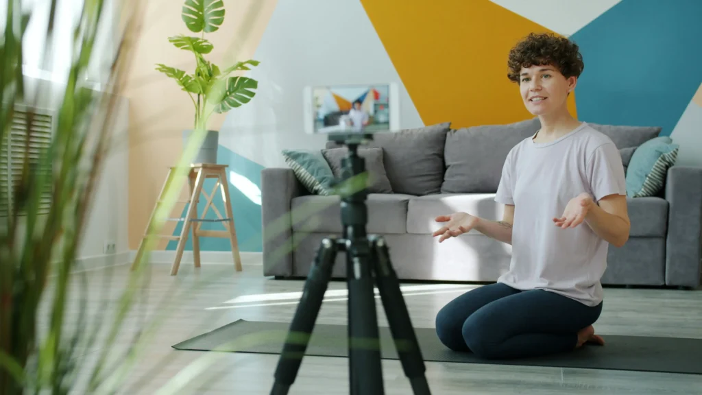Woman filming her workout at home with a tripod
