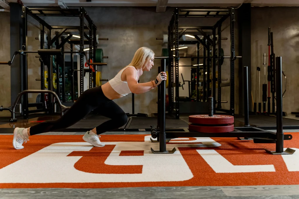 Woman training on push-pull machine at the gym