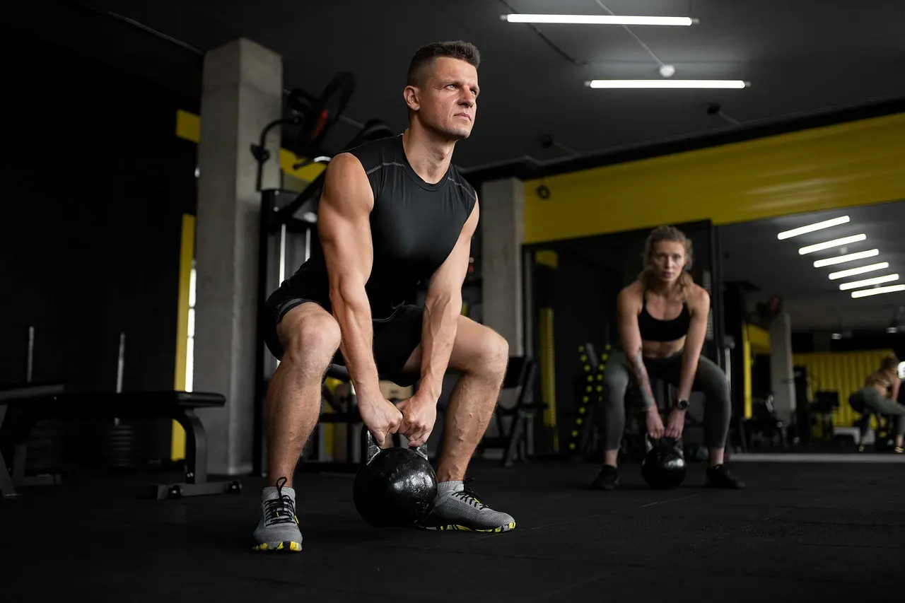Photo of a man training with a kettlebell in the gym