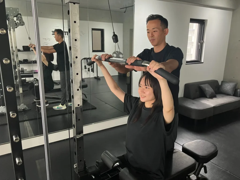 体験トレーニングでラットプルダウンをするデザイナーNさん