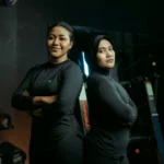 ジムで腕組をして立つ2人の女性