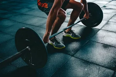 Close-up of a person preparing to lift a barbell
