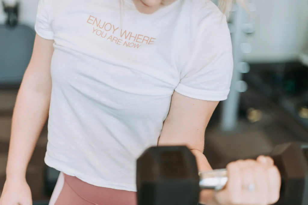 Woman working out with dumbbells at a personal gym